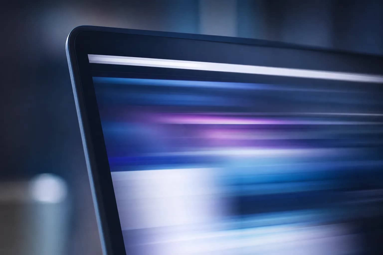 Macro shot of a laptop screen edge with a page loading extremely fast, light streaks